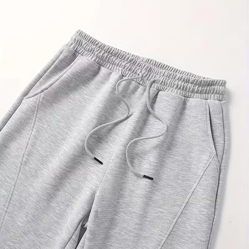 Men's unisex wide-leg sweatpants, loose and breathable polyester casual trousers with drawstring design, and solid color paneling
