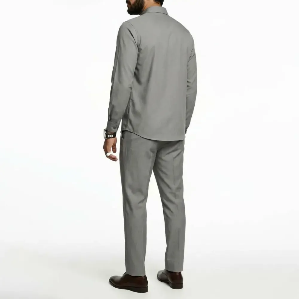 A minimalist men's business suit includes a long-sleeved shirt and straight-leg trousers.